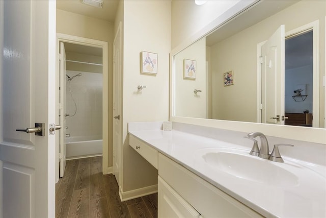 bathroom with tiled shower / bath, vanity, and hardwood / wood-style flooring