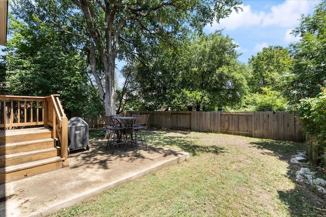 view of yard with a wooden deck and a patio