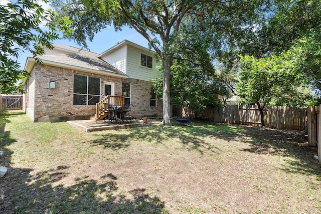 back of property featuring a lawn