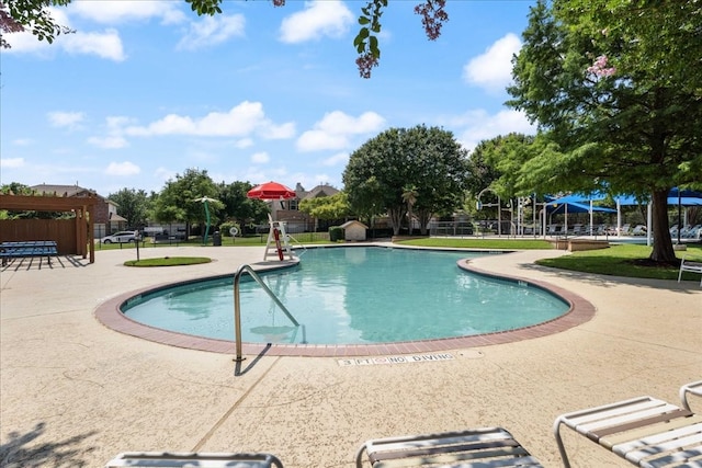 view of swimming pool featuring a patio area