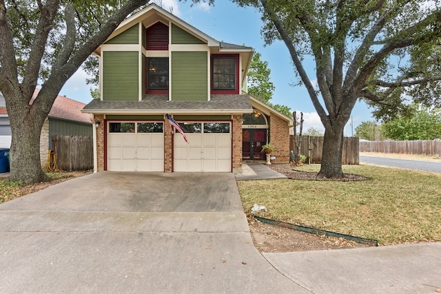 view of front of house with a garage and a front lawn