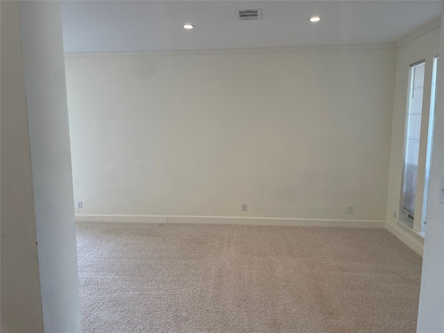 carpeted empty room with crown molding