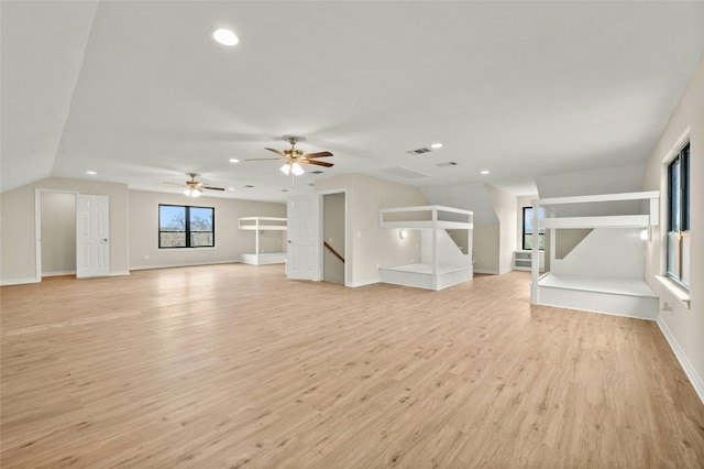 unfurnished living room with lofted ceiling, light hardwood / wood-style flooring, and ceiling fan