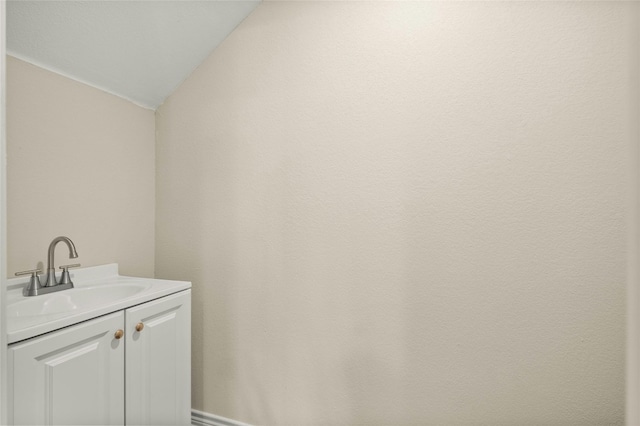 bathroom with vanity and vaulted ceiling