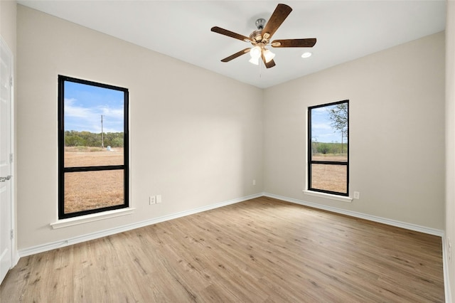 spare room featuring light wood-type flooring and ceiling fan