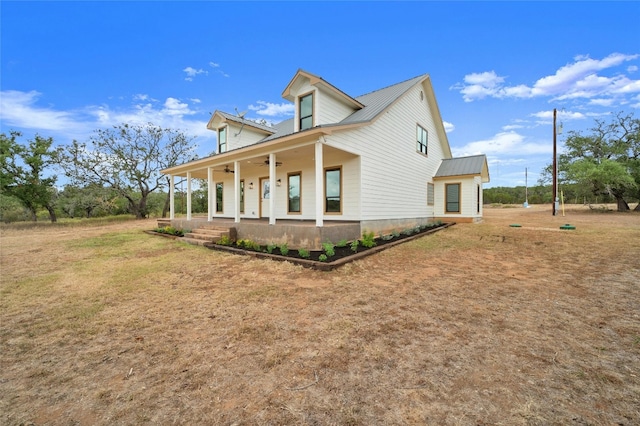 view of side of property with a porch