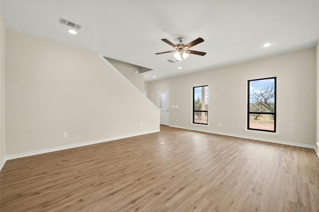 unfurnished living room featuring ceiling fan and light hardwood / wood-style flooring