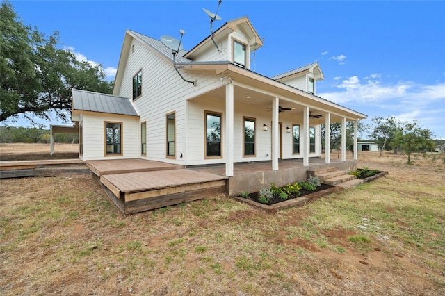 back of property featuring a deck, a lawn, and ceiling fan