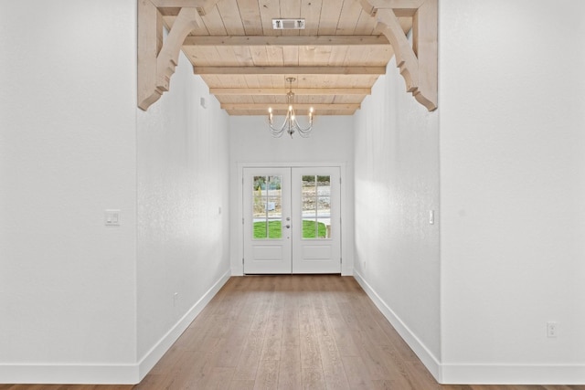 doorway to outside with wooden ceiling, an inviting chandelier, french doors, hardwood / wood-style flooring, and beamed ceiling