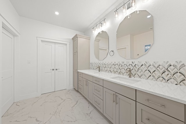 bathroom featuring vanity and decorative backsplash