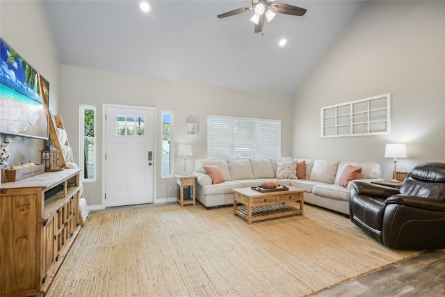 living room with ceiling fan, high vaulted ceiling, and wood-type flooring