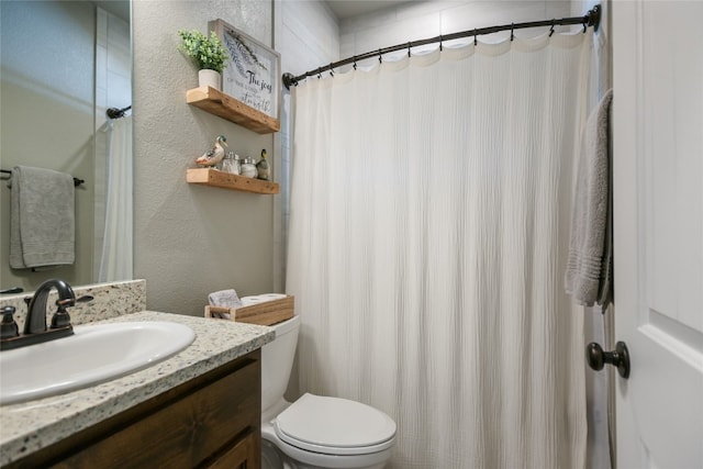 bathroom featuring toilet, a shower with curtain, and vanity