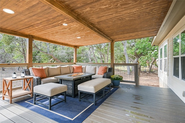 wooden deck with an outdoor living space with a fire pit