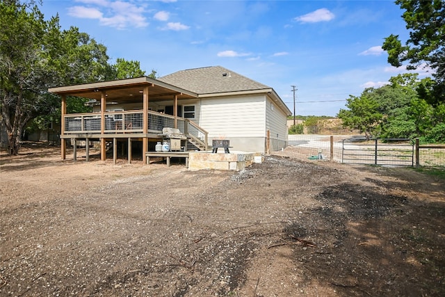 back of property featuring a wooden deck