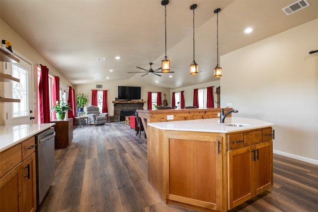 kitchen featuring lofted ceiling, dishwasher, a center island with sink, and dark hardwood / wood-style floors