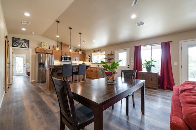 dining area featuring sink, vaulted ceiling, and dark hardwood / wood-style floors