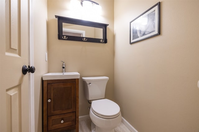 bathroom with toilet and vanity