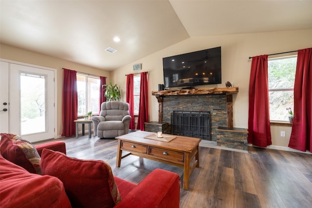 living room with french doors, a stone fireplace, wood-type flooring, and lofted ceiling