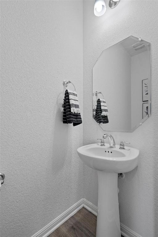 bathroom with hardwood / wood-style floors