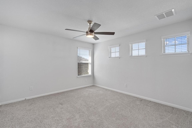 empty room featuring carpet floors and ceiling fan