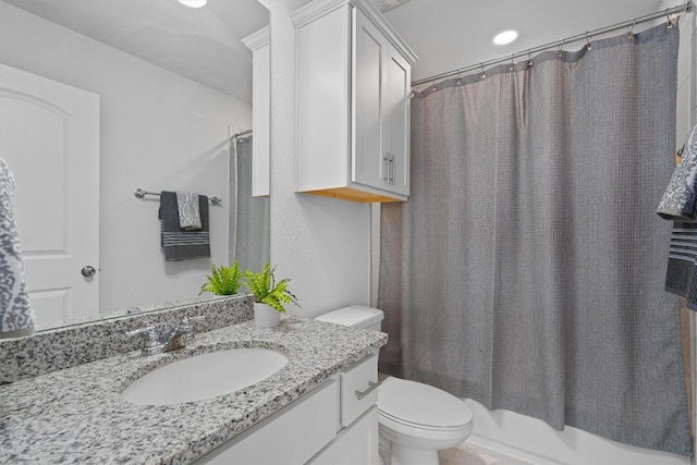 full bathroom featuring vanity, shower / bath combination with curtain, and toilet