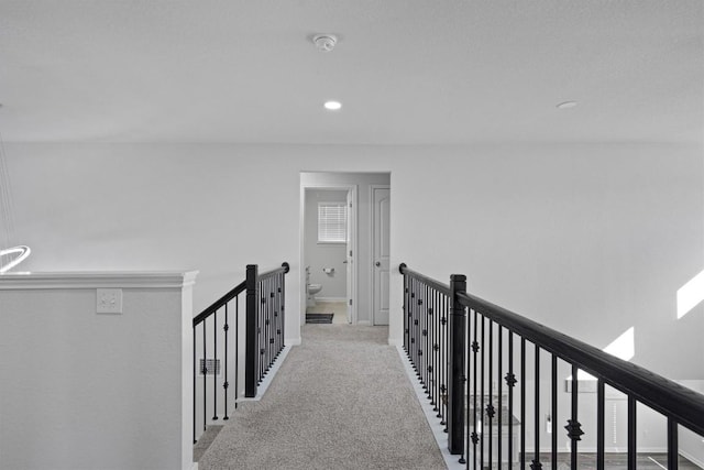 corridor with light colored carpet