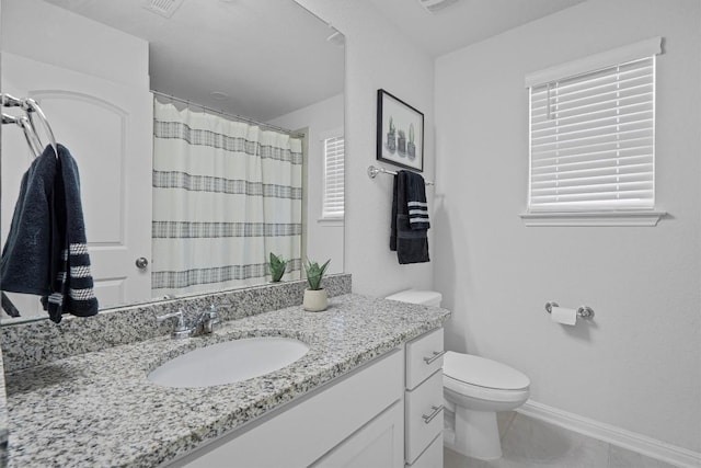 bathroom featuring tile patterned flooring, vanity, curtained shower, and toilet