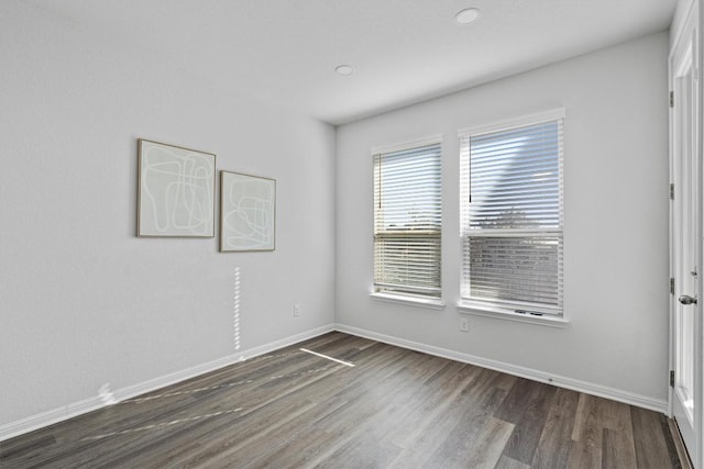 spare room with dark wood-type flooring