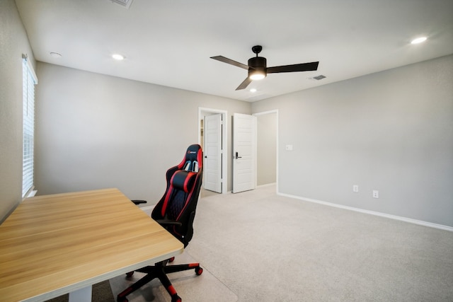 office with light carpet and ceiling fan