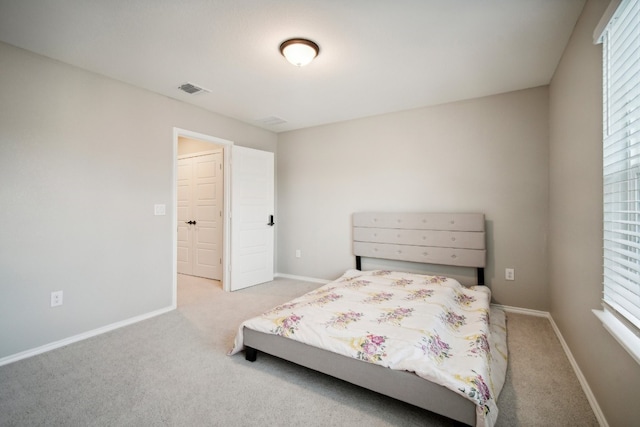 unfurnished bedroom with multiple windows and light colored carpet