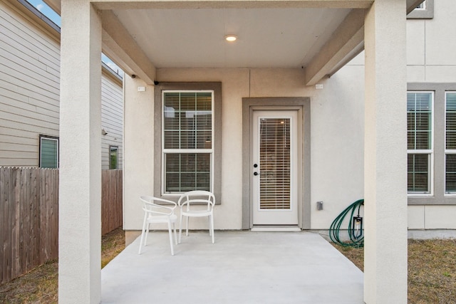 view of exterior entry with a patio