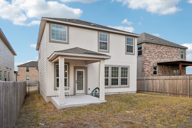 rear view of house featuring a patio and a lawn