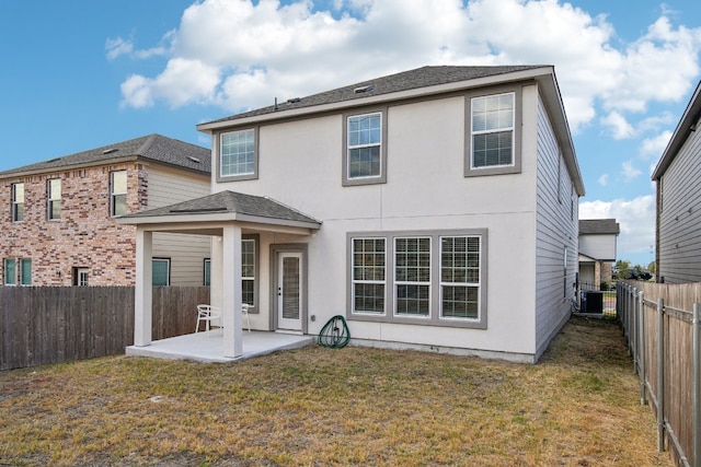 rear view of property featuring central air condition unit, a patio area, and a lawn