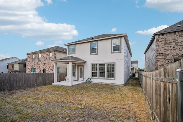 rear view of house with a yard and a patio area