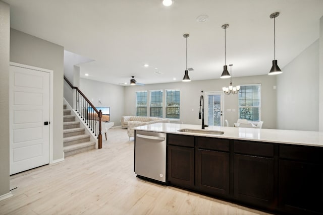 kitchen featuring stainless steel dishwasher, a wealth of natural light, sink, and light wood-type flooring