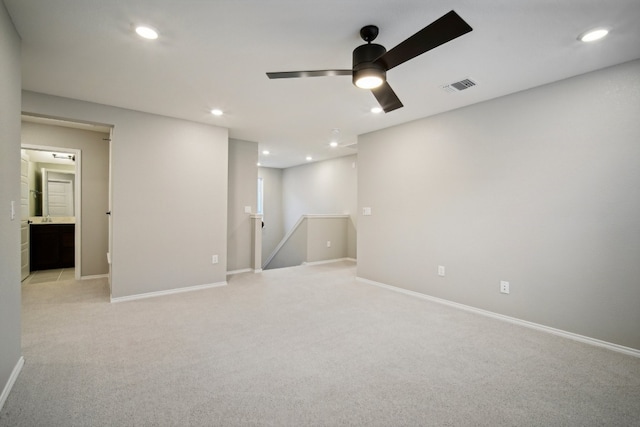 carpeted empty room featuring ceiling fan