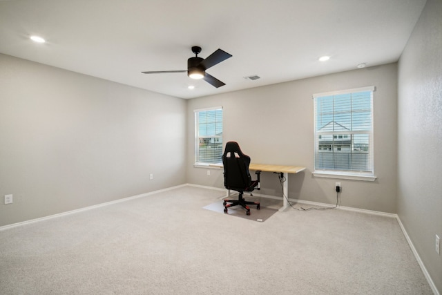 carpeted office featuring ceiling fan