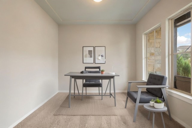 carpeted home office with baseboards