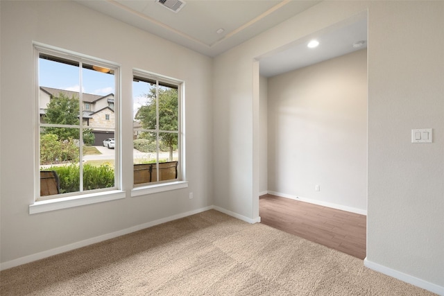 carpeted spare room with recessed lighting, visible vents, and baseboards