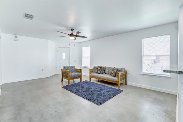 living room with concrete flooring, a textured ceiling, and ceiling fan