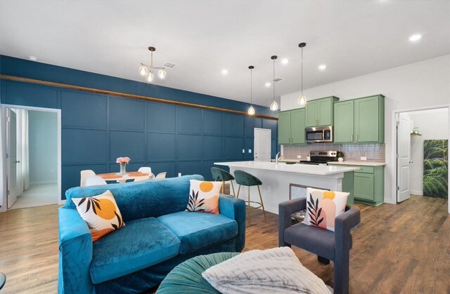 living room with dark wood-type flooring and sink