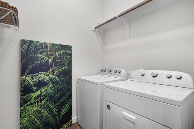 laundry room featuring washing machine and dryer and wood-type flooring