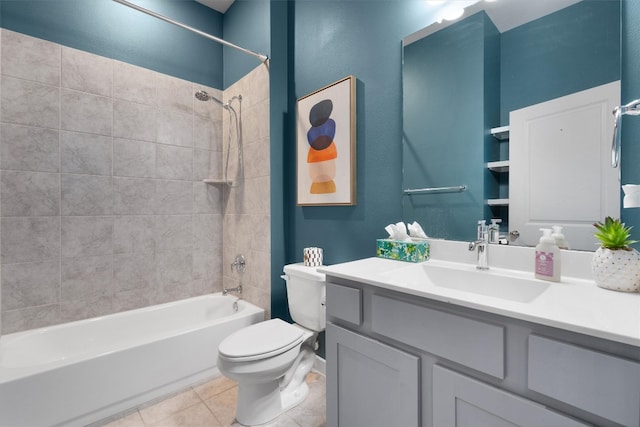 full bathroom with tile patterned flooring, tiled shower / bath combo, toilet, and vanity