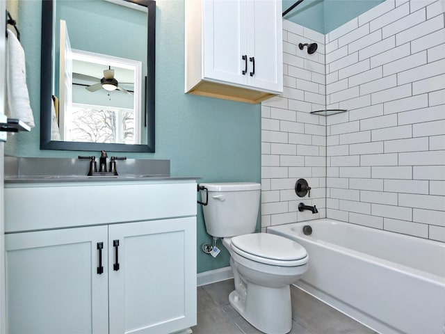 full bathroom featuring ceiling fan, vanity, toilet, and tiled shower / bath