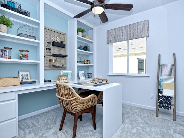 carpeted dining area featuring built in desk and ceiling fan