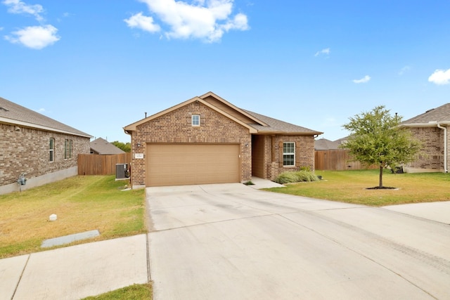 view of front of home with a garage, a front yard, and central AC