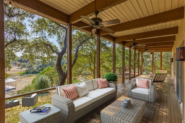 sunroom / solarium featuring wooden ceiling, a wealth of natural light, ceiling fan, and beam ceiling