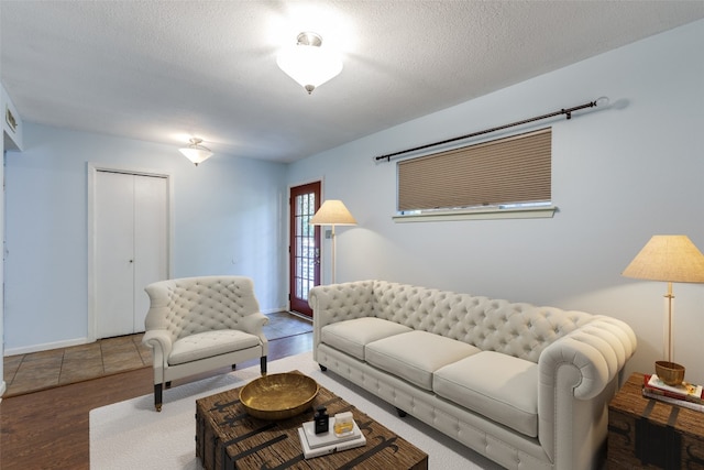 living room with hardwood / wood-style floors and a textured ceiling