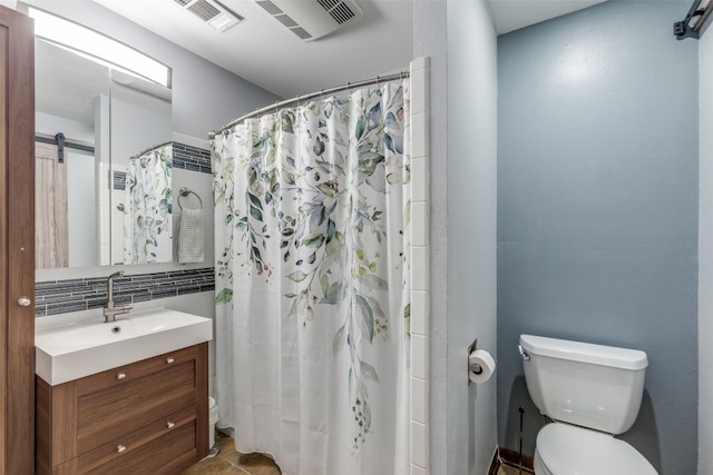 bathroom with walk in shower, backsplash, vanity, tile patterned floors, and toilet