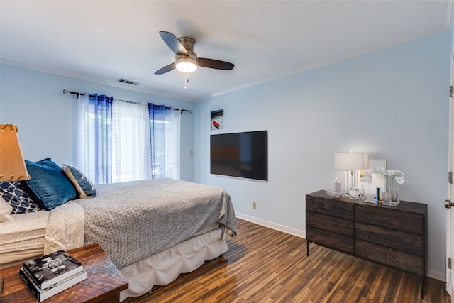 bedroom with ceiling fan, dark hardwood / wood-style floors, and crown molding